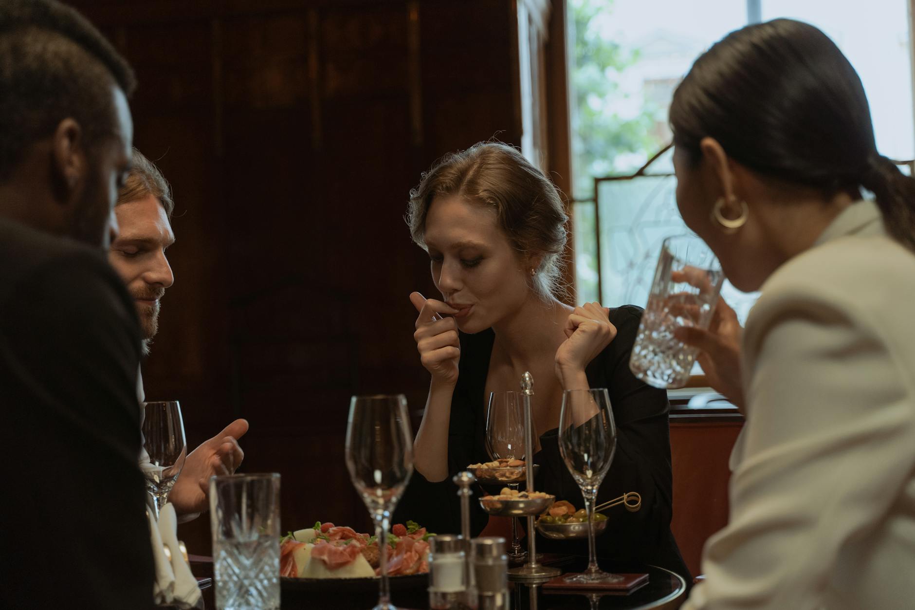 Friends dining at a restaurant table in the evening