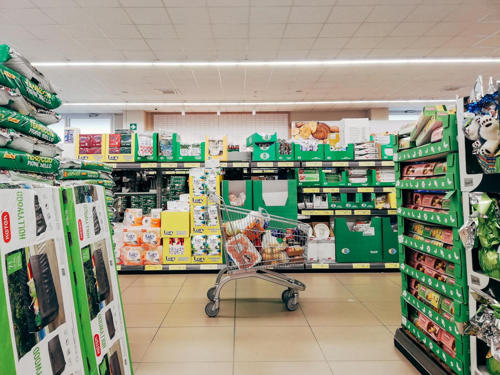 Grocery shelves and a shopping trolley