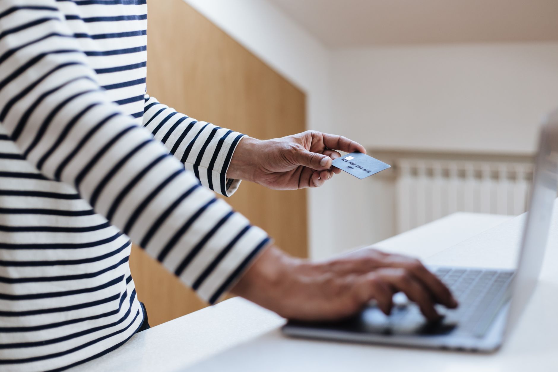 Paying online with a credit card at a laptop