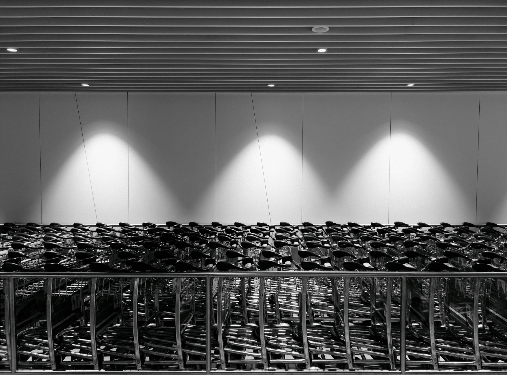 Stacked supermarket trolleys in a black-and-white frame