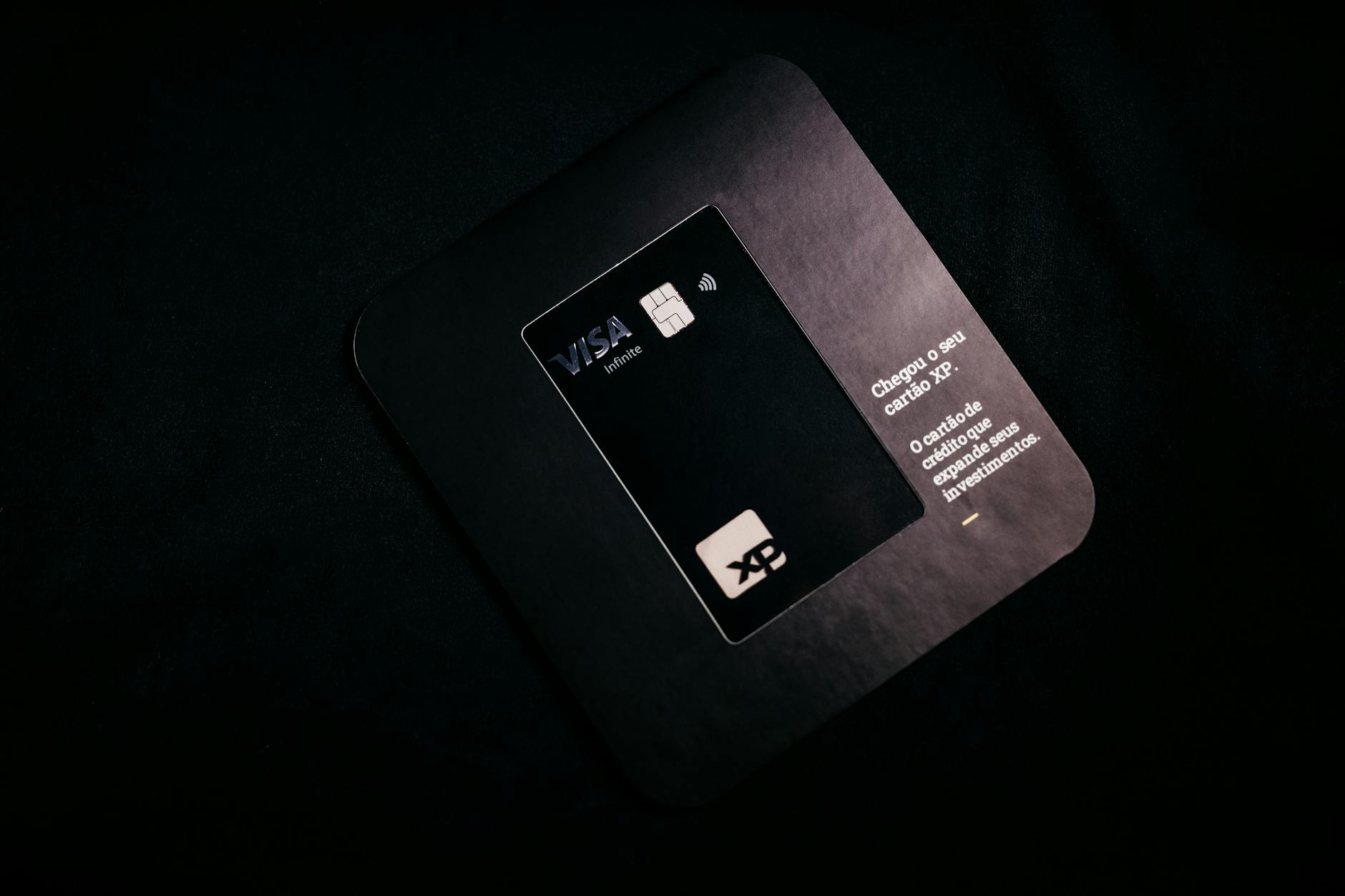 Premium black credit card on a luxury desk