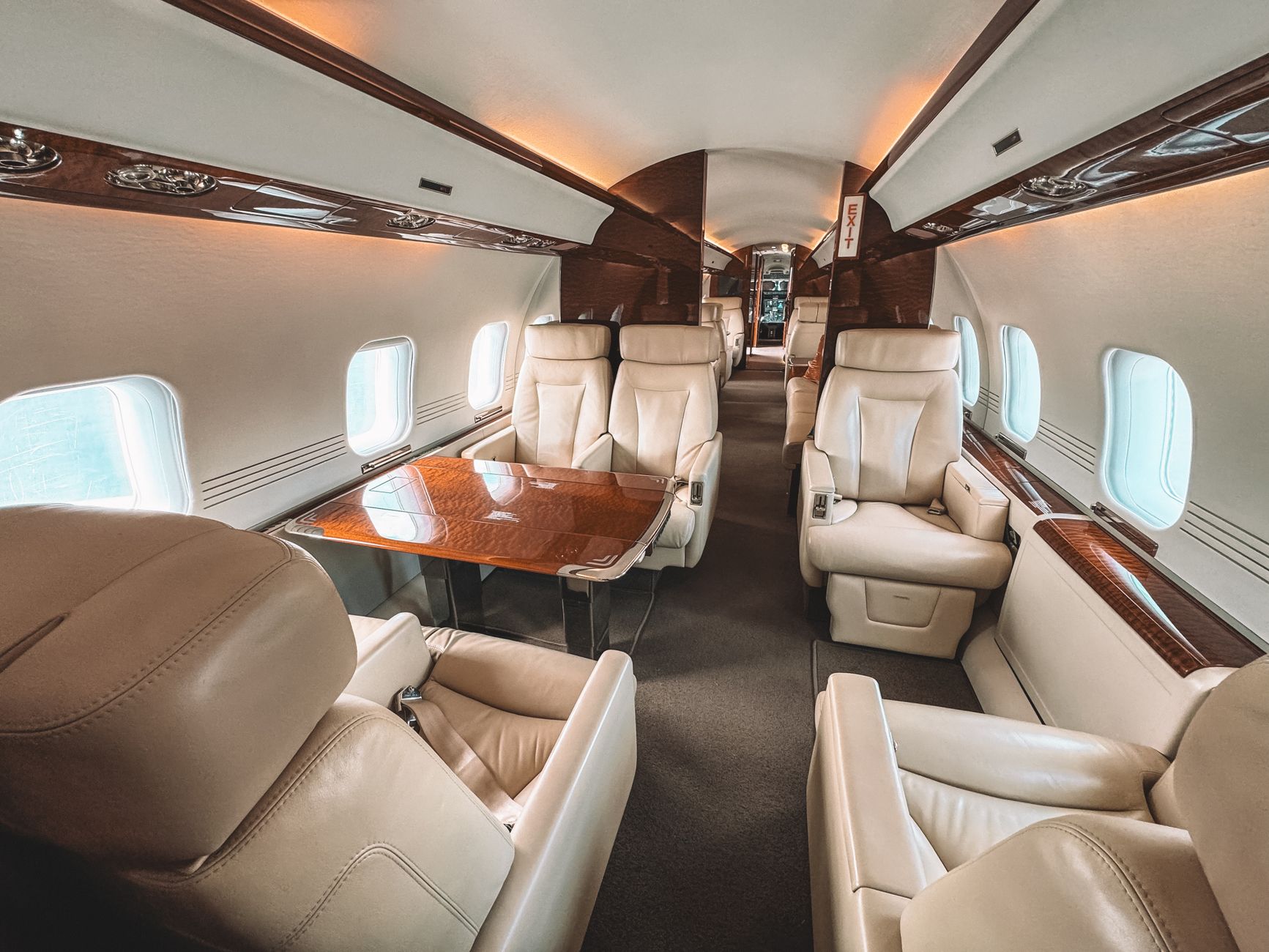 A premium aircraft cabin with cream leather seats — the sharp end of the plane UAE points can unlock