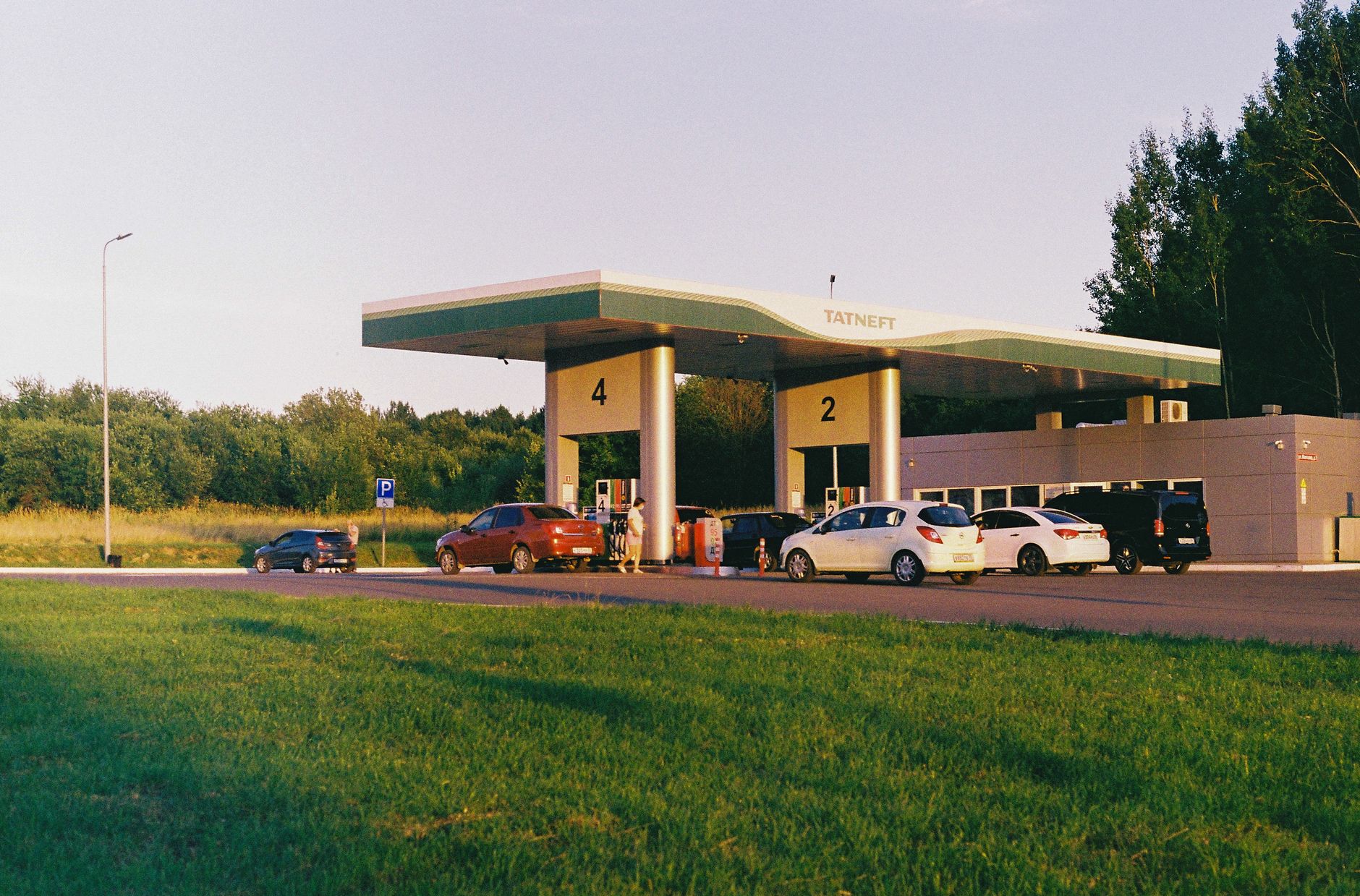 Refuelling a car on a modern service-station forecourt in daylight