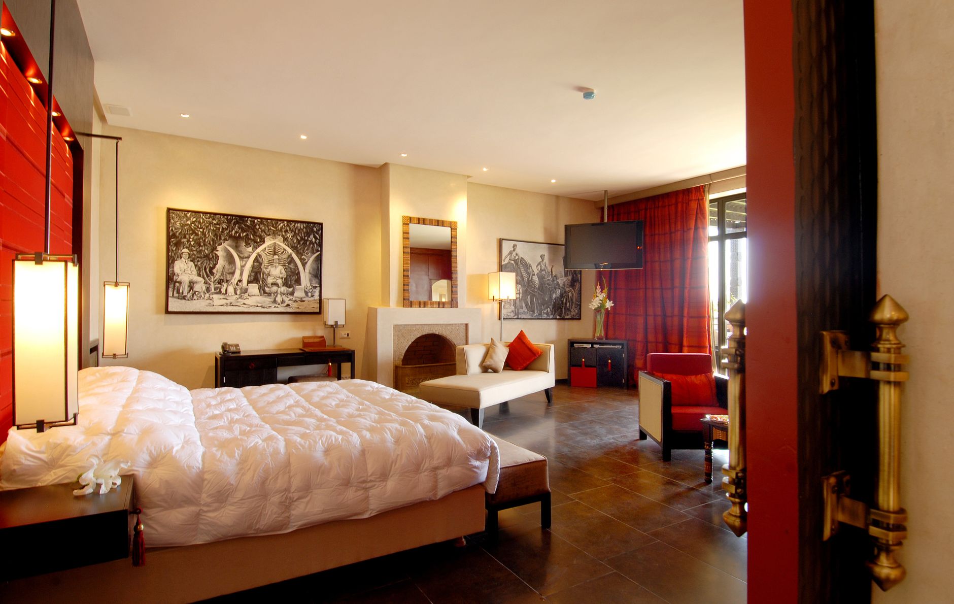 An upscale hotel bedroom in warm neutral tones — the upper-tier stays Hilton Honors points unlock